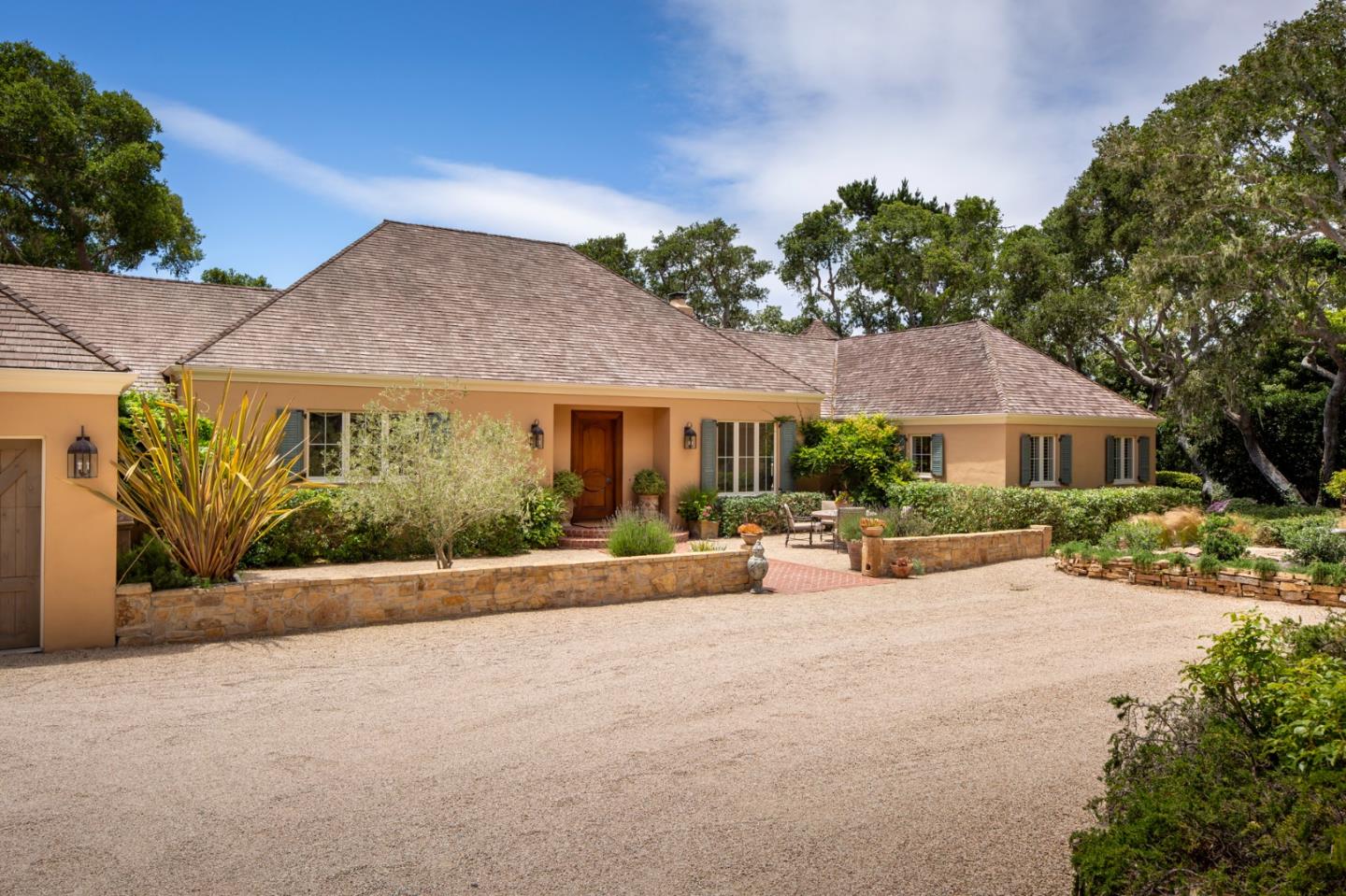 a view of a house with sitting area and garden