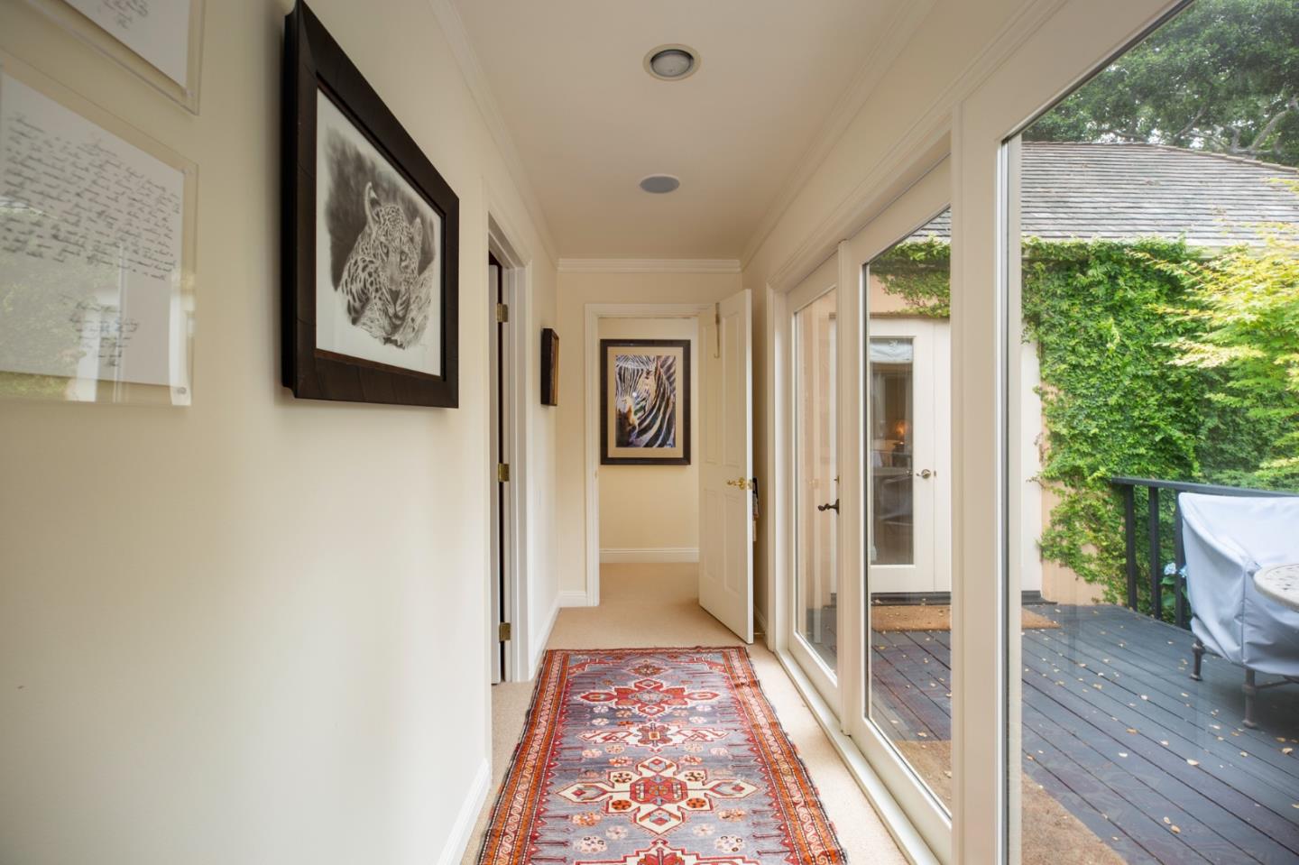 1534 Riata Road Pebble Beach, CA 93953 - Photo 11 of 50 a view of a hallway with wooden floor and a floor to ceiling window