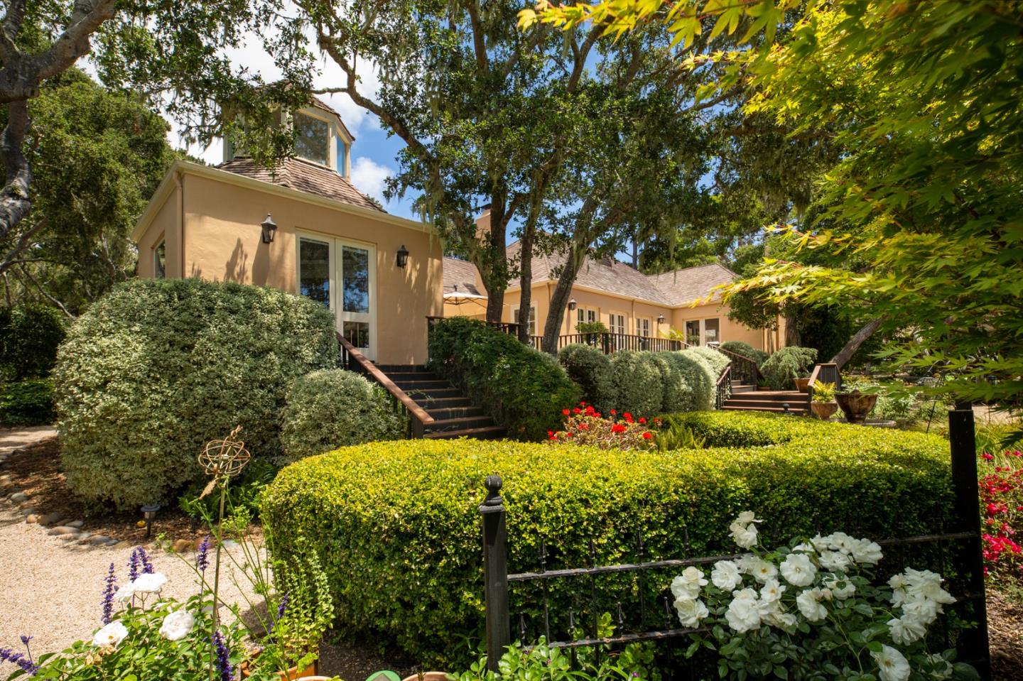 1534 Riata Road Pebble Beach, CA 93953 - Photo 42 of 50 a front view of a house with a yard and covered with trees