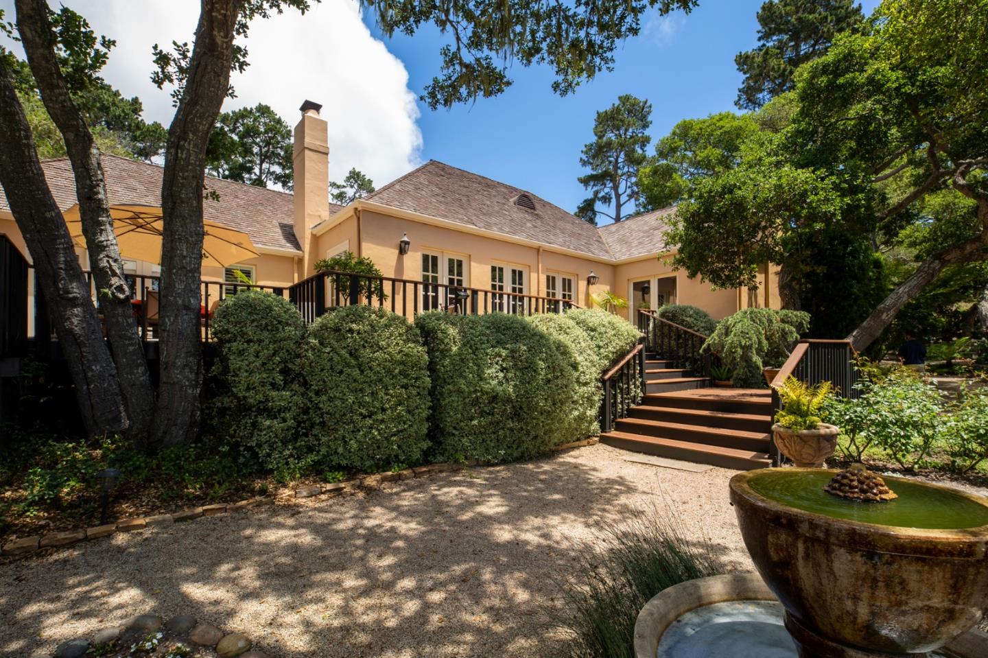 1534 Riata Road Pebble Beach, CA 93953 - Photo 44 of 50 a front view of a house with garden