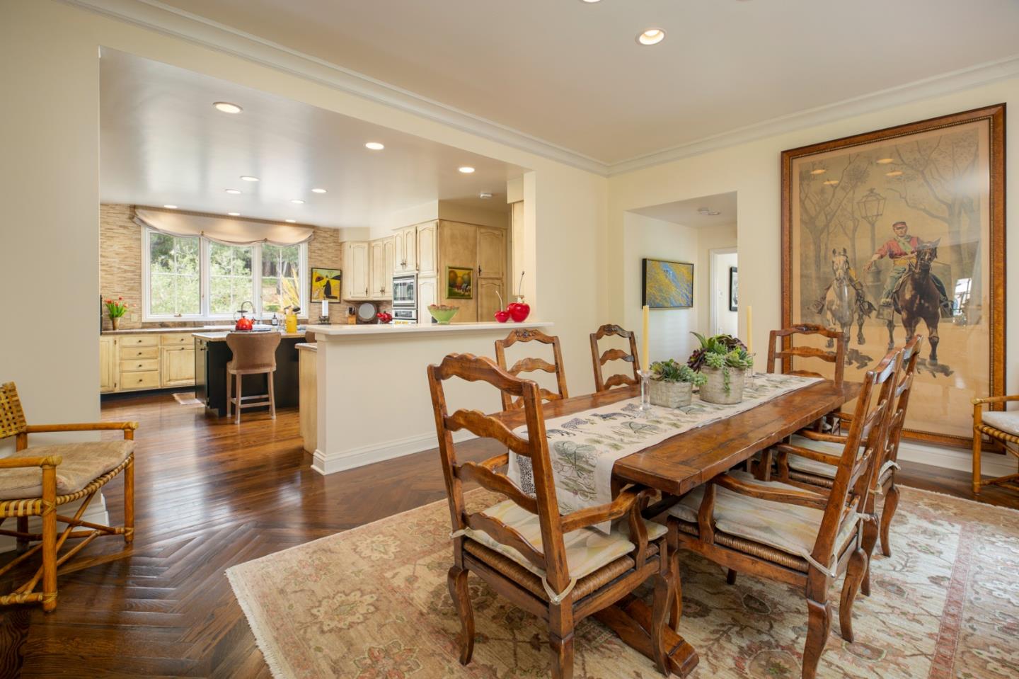 1534 Riata Road Pebble Beach, CA 93953 - Photo 5 of 50 a dining room with wooden floor a glass table and chairs