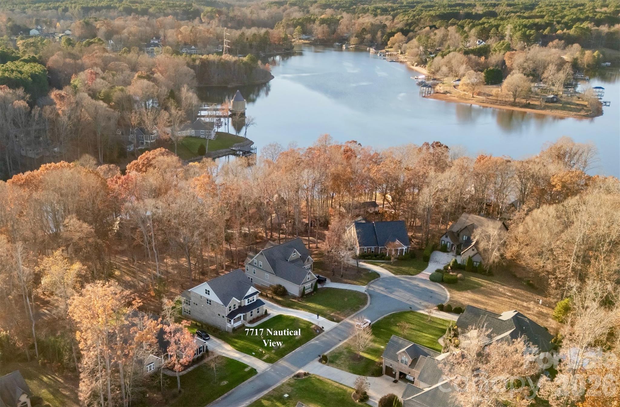 an aerial view of a house with a lake view
