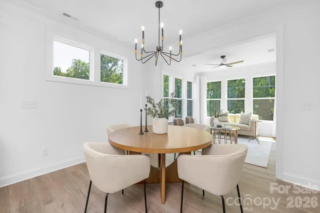 a bedroom with a bed and painting on the wall