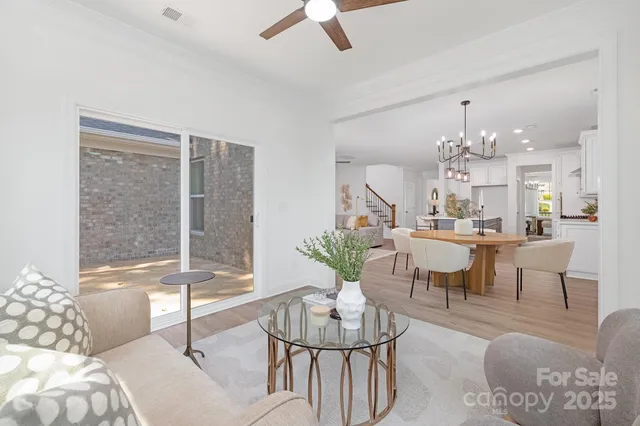 a living room with furniture and a chandelier
