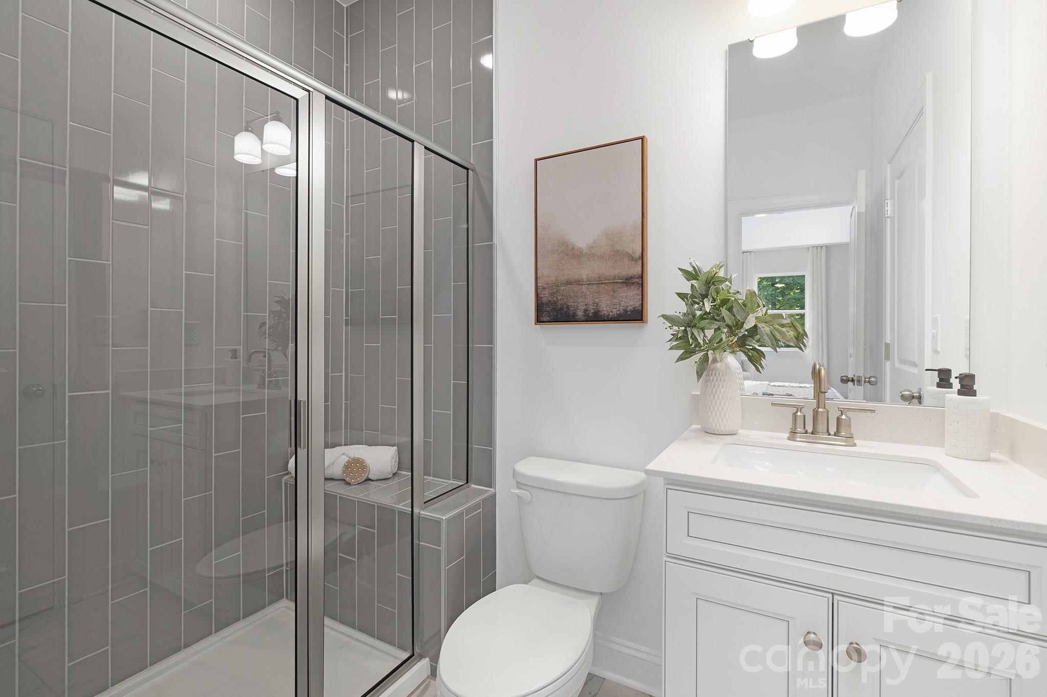 7717 Nautical View Denver, NC 28037 - Photo 22 of 43 a bathroom with a toilet a sink and shower