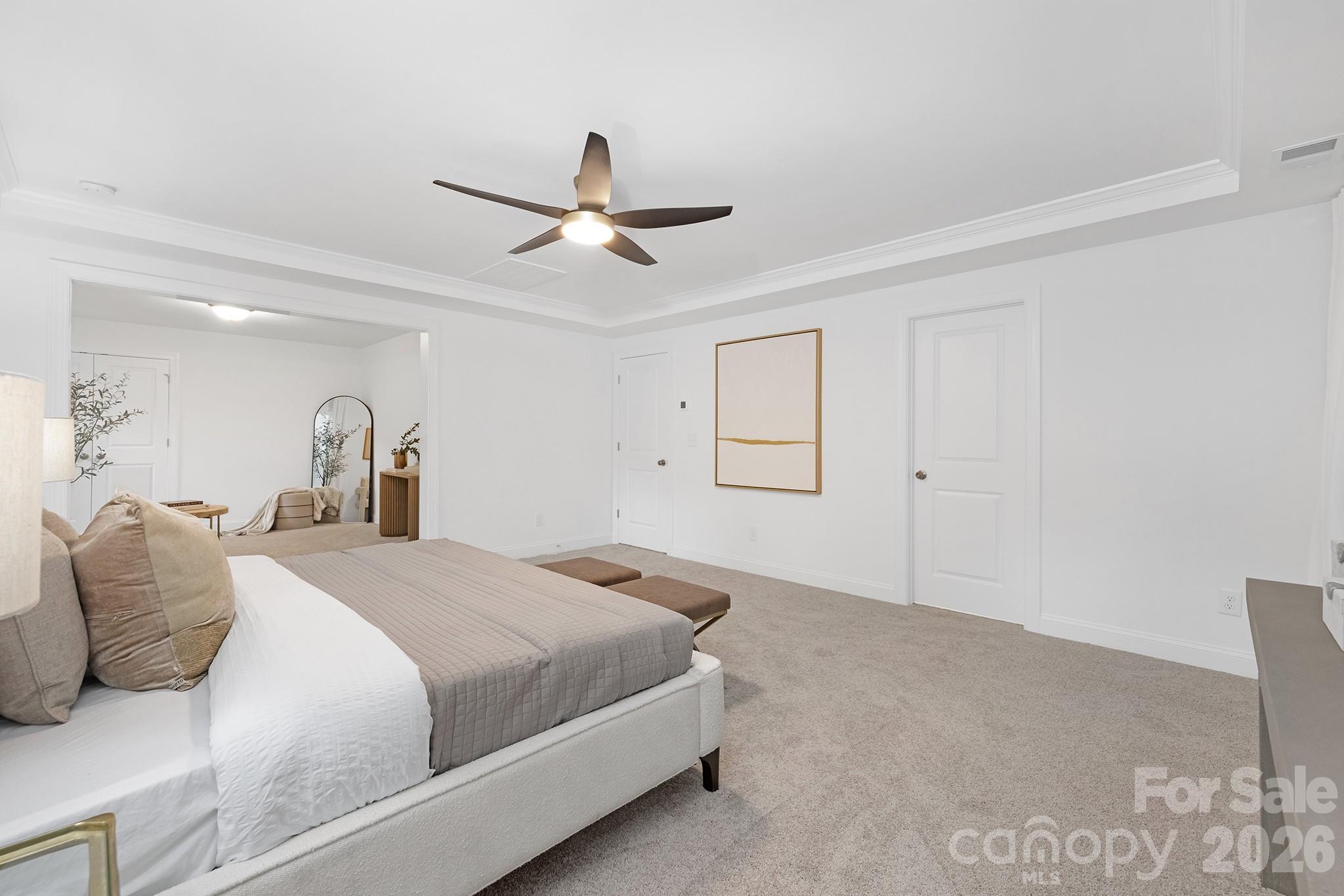 7717 Nautical View Denver, NC 28037 - Photo 23 of 43 a bedroom with a bed and a ceiling fan
