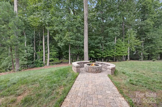 a view of a backyard with table and chairs