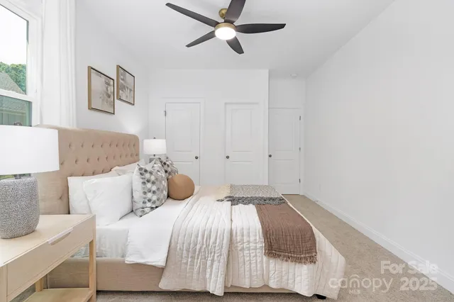 a bedroom with a bed and painting on the wall