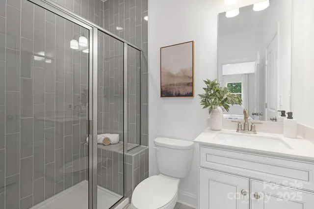 a bathroom with a toilet a sink and shower