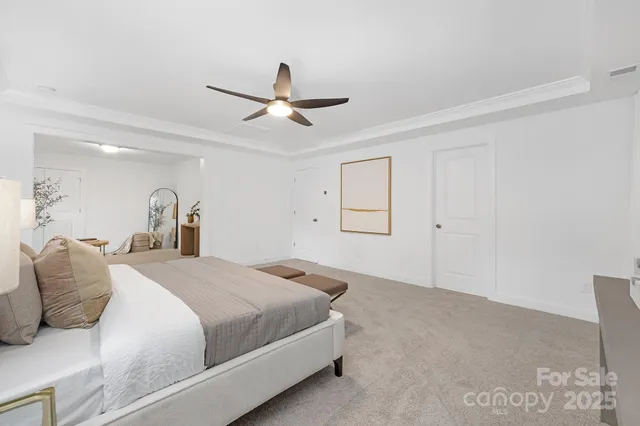 a bedroom with a bed and a ceiling fan