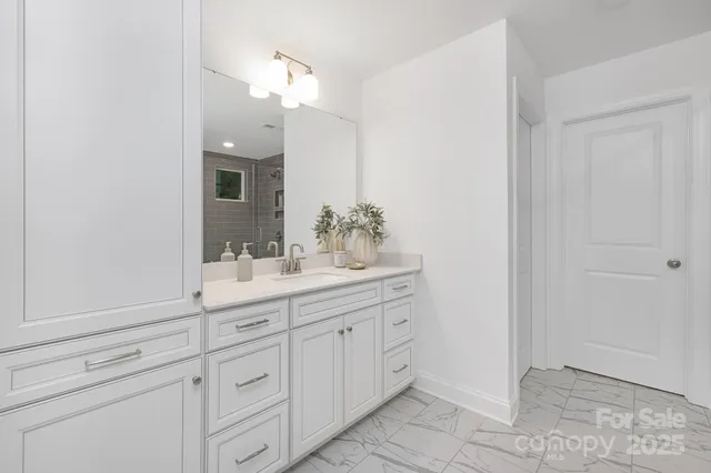 a bathroom with a sink vanity and a mirror