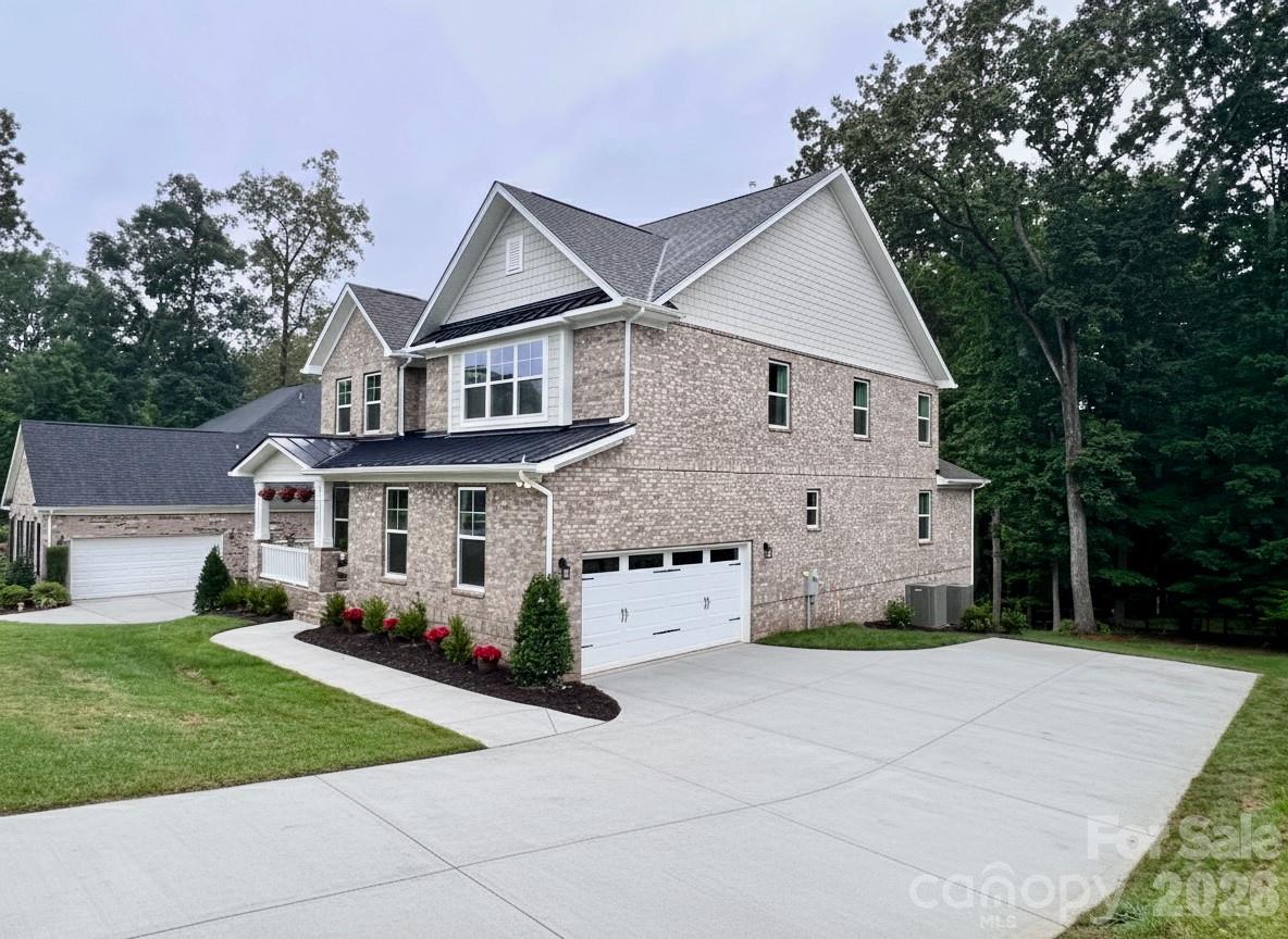 7717 Nautical View Denver, NC 28037 - Photo 4 of 43 a front view of a house with a yard and trees