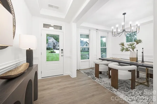 a view of a dining room with furniture window and wooden floor