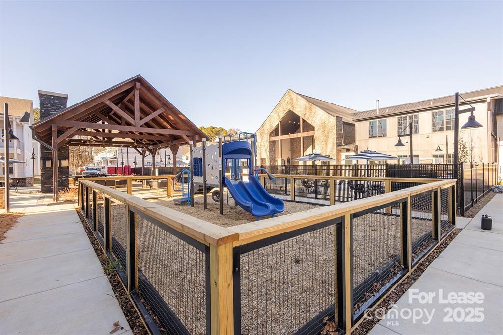 3110 Doe River Way, Unit RHODES Matthews, NC 28105 - Photo 4 of 48 a view of a house with wooden deck and furniture