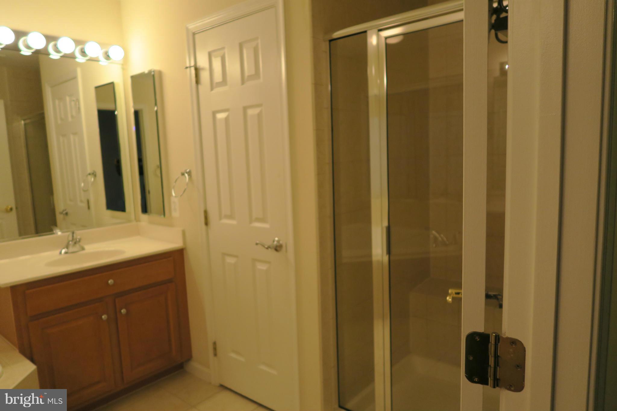 725 Ridgemont Avenue Rockville, MD 20850 - Photo 14 of 17 a bathroom with a shower sink and mirror