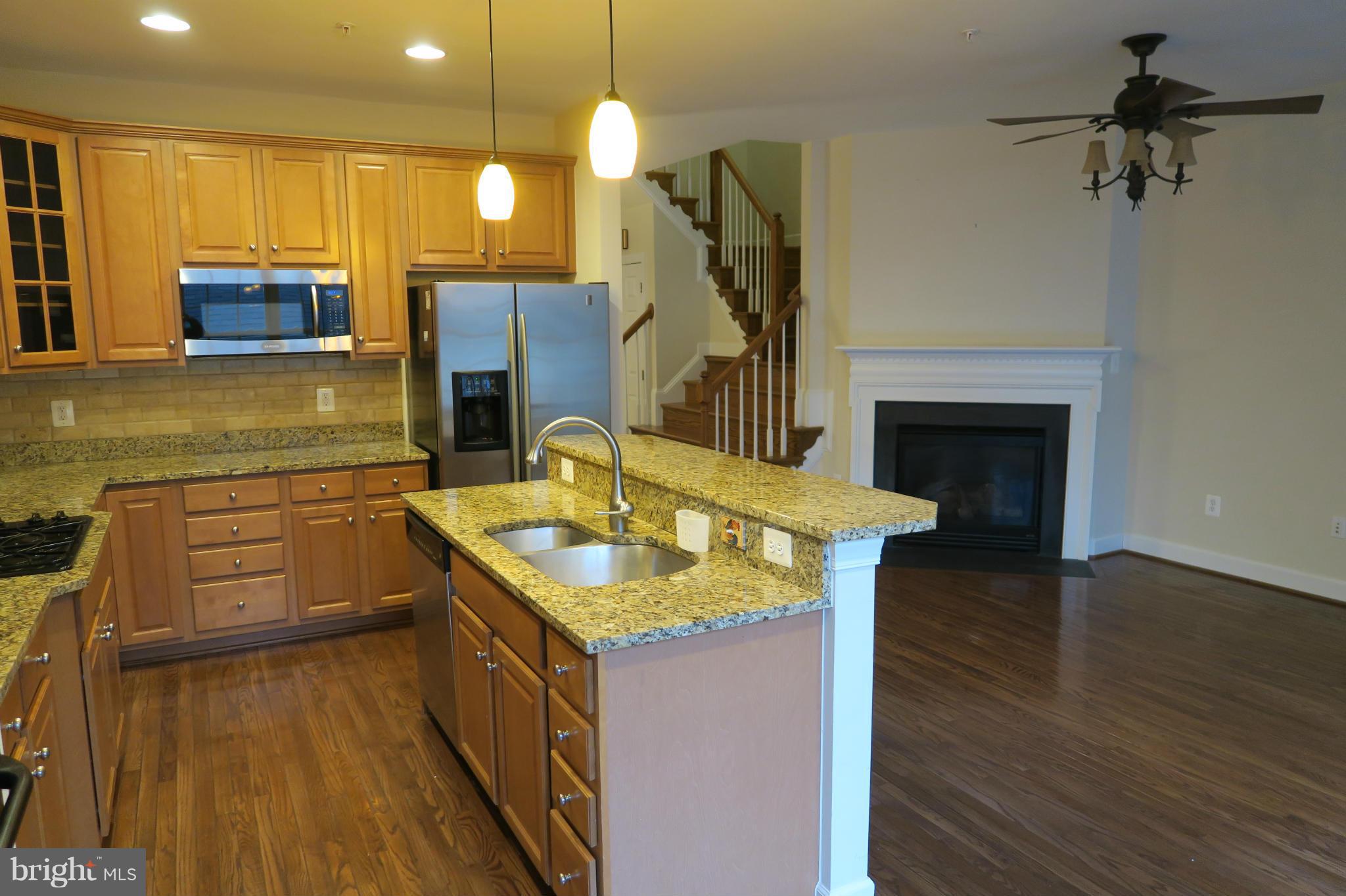 725 Ridgemont Avenue Rockville, MD 20850 - Photo 4 of 17 a kitchen with a sink appliances and cabinets