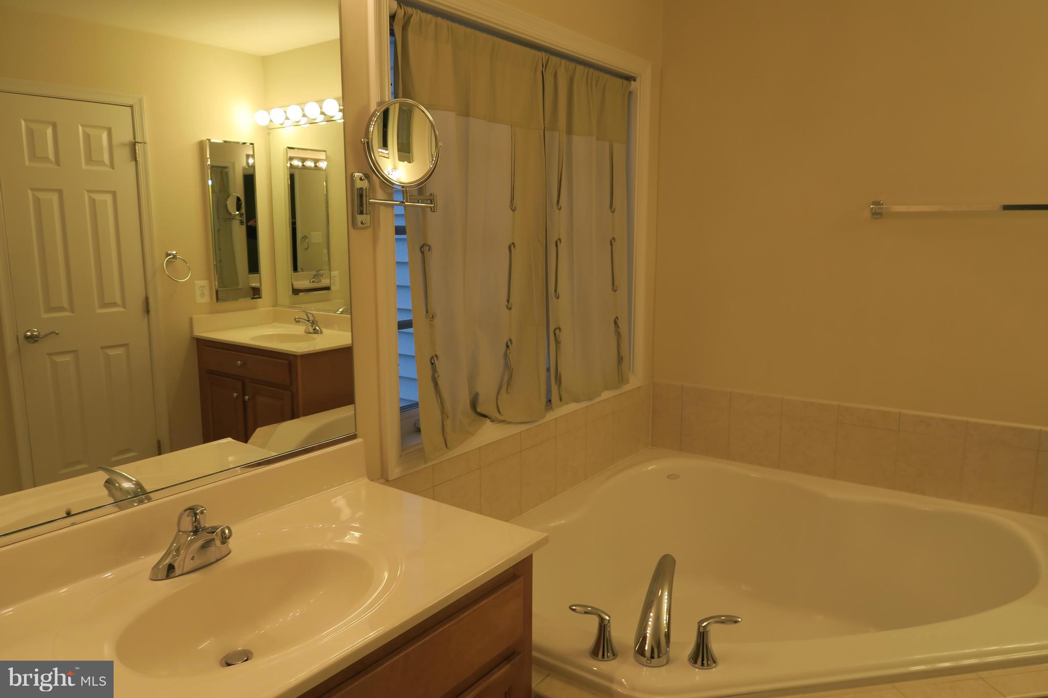 725 Ridgemont Avenue Rockville, MD 20850 - Photo 6 of 17 a bathroom with a sink and a tub