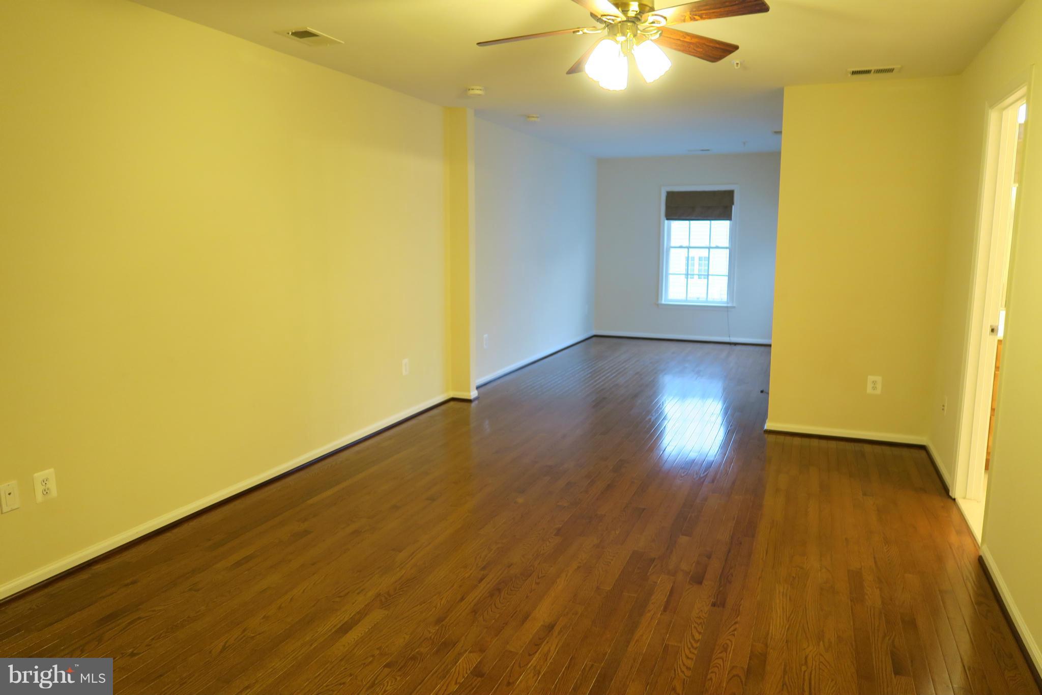 725 Ridgemont Avenue Rockville, MD 20850 - Photo 7 of 17 a view of an empty room with wooden floor and a window