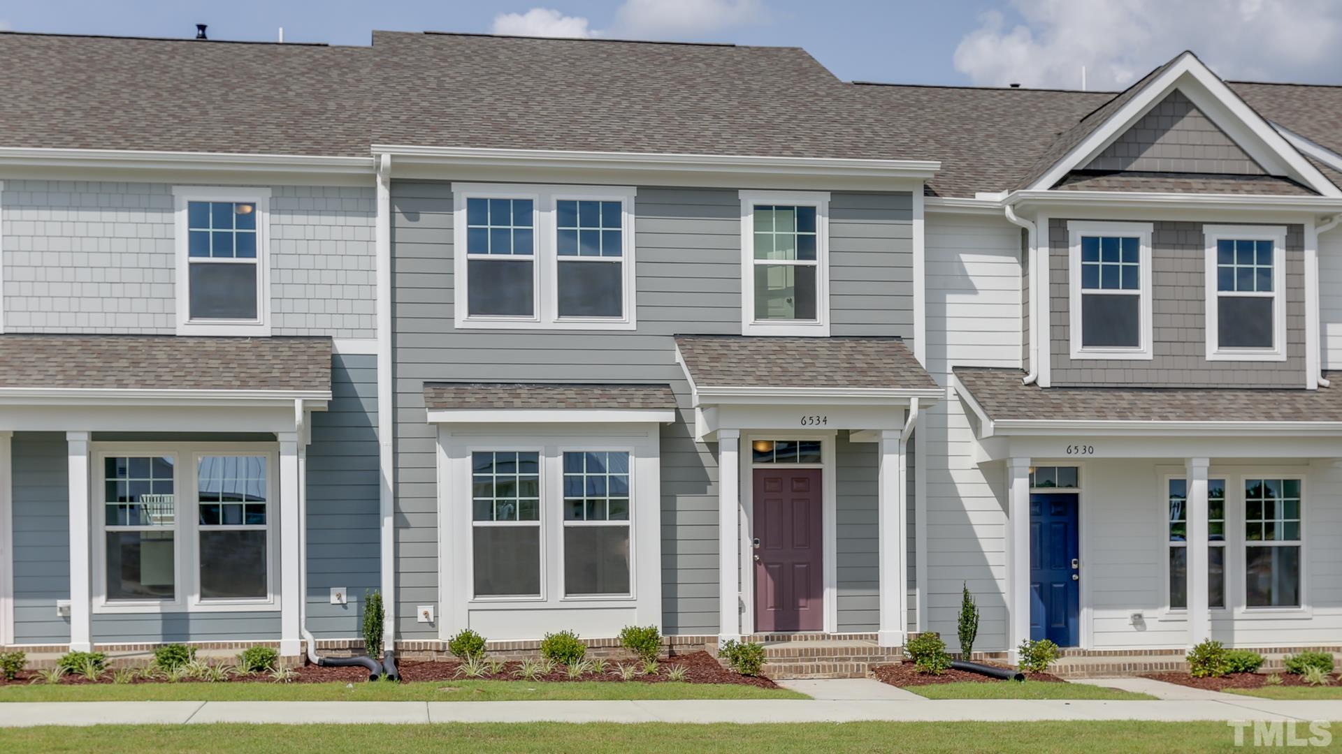 5021 Crescent Square Street, Unit 2428 Raleigh, NC 27616 - Photo 2 of 6 front view of a brick house many windows and large trees