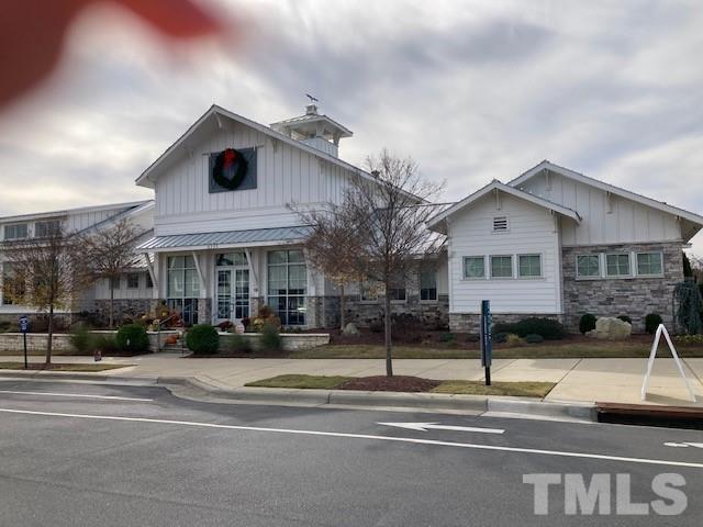 5021 Crescent Square Street, Unit 2428 Raleigh, NC 27616 - Photo 4 of 6 a view of a white house with a large windows and a table and chairs