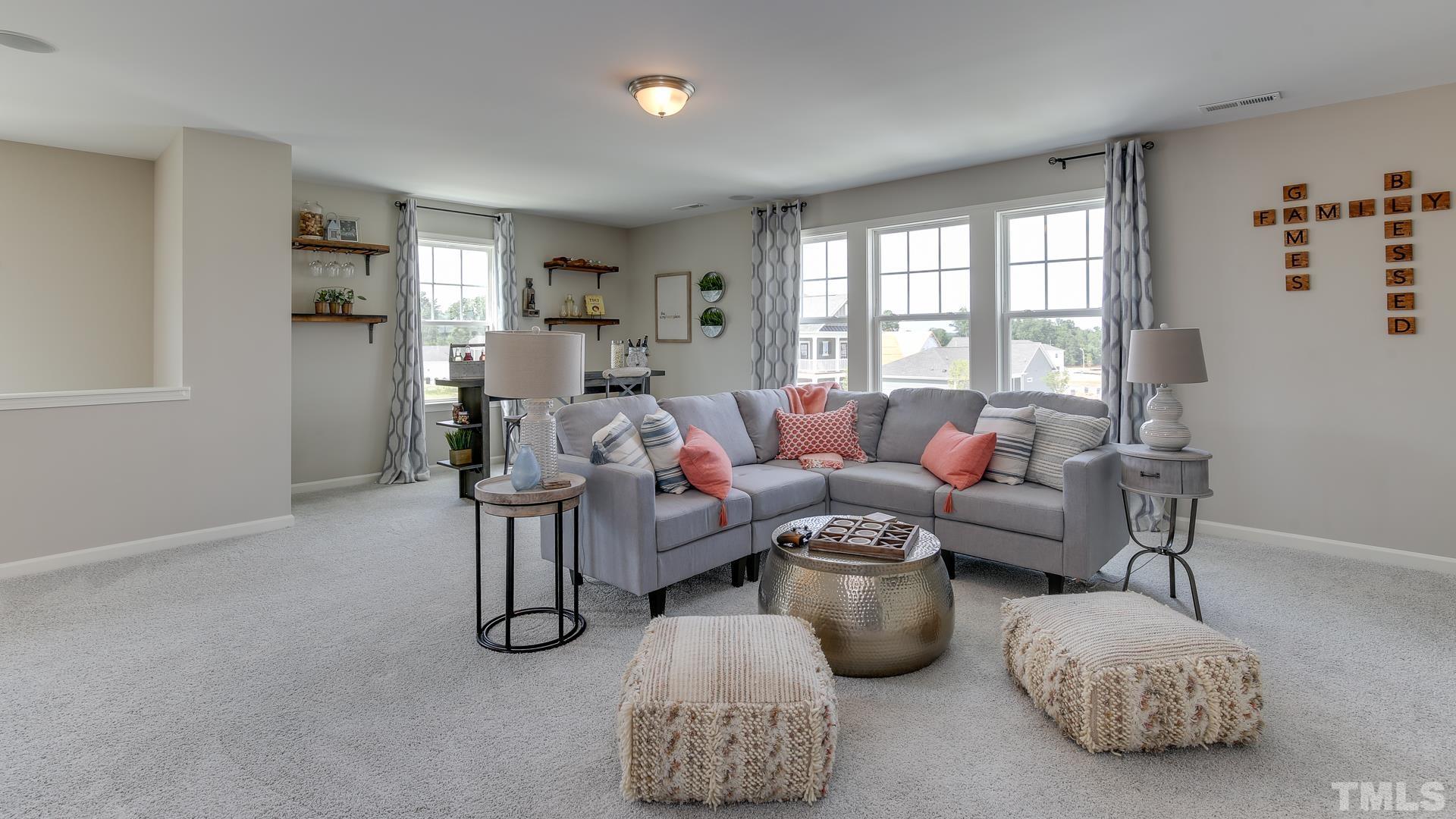 5021 Crescent Square Street, Unit 2428 Raleigh, NC 27616 - Photo 6 of 6 a living room with furniture and a large window