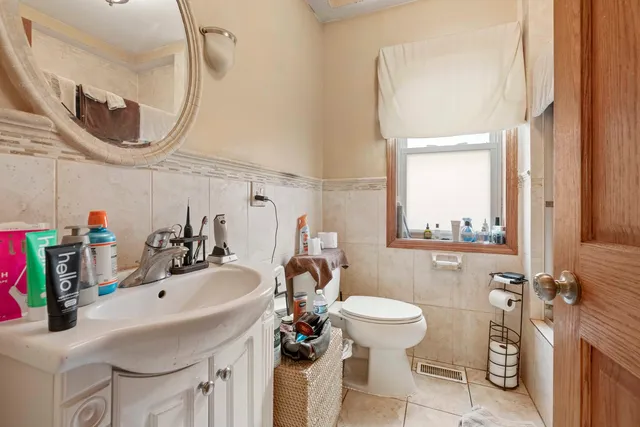 a bathroom with a sink a toilet and a mirror