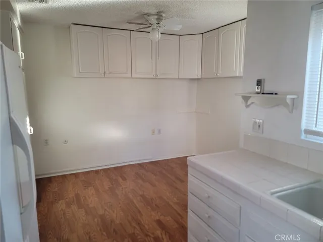 a kitchen with refrigerator a stove a sink and a microwave