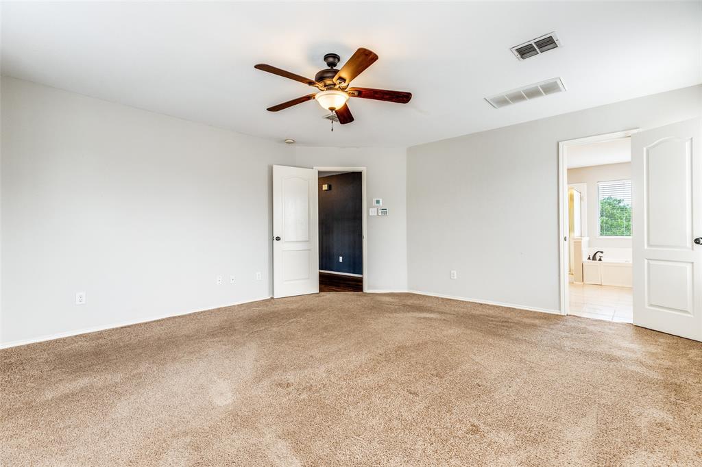 1445 Berkley Road Allen, TX 75002 - Photo 15 of 30 The primary bedroom with ensuite bath is separated from the other bedrooms for privacy and there is a large, deep linen closet just outside the door in the hallway.