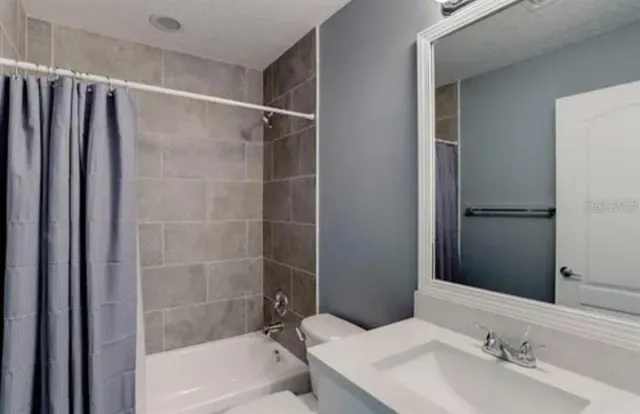 a bathroom with a bathtub and a sink