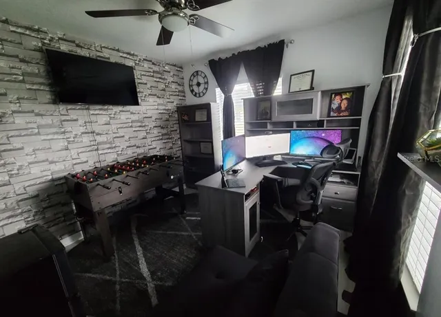 a living room with flat screen tv and a fireplace