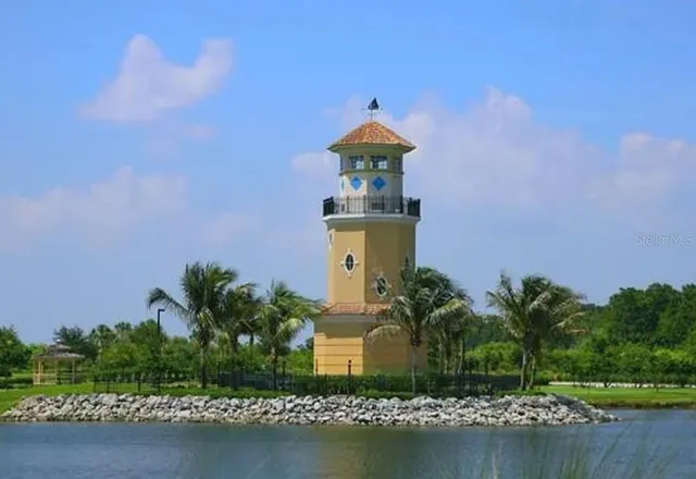 a front view of a house with a yard and a garden
