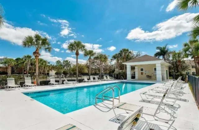 a view of a house with swimming pool and sitting area