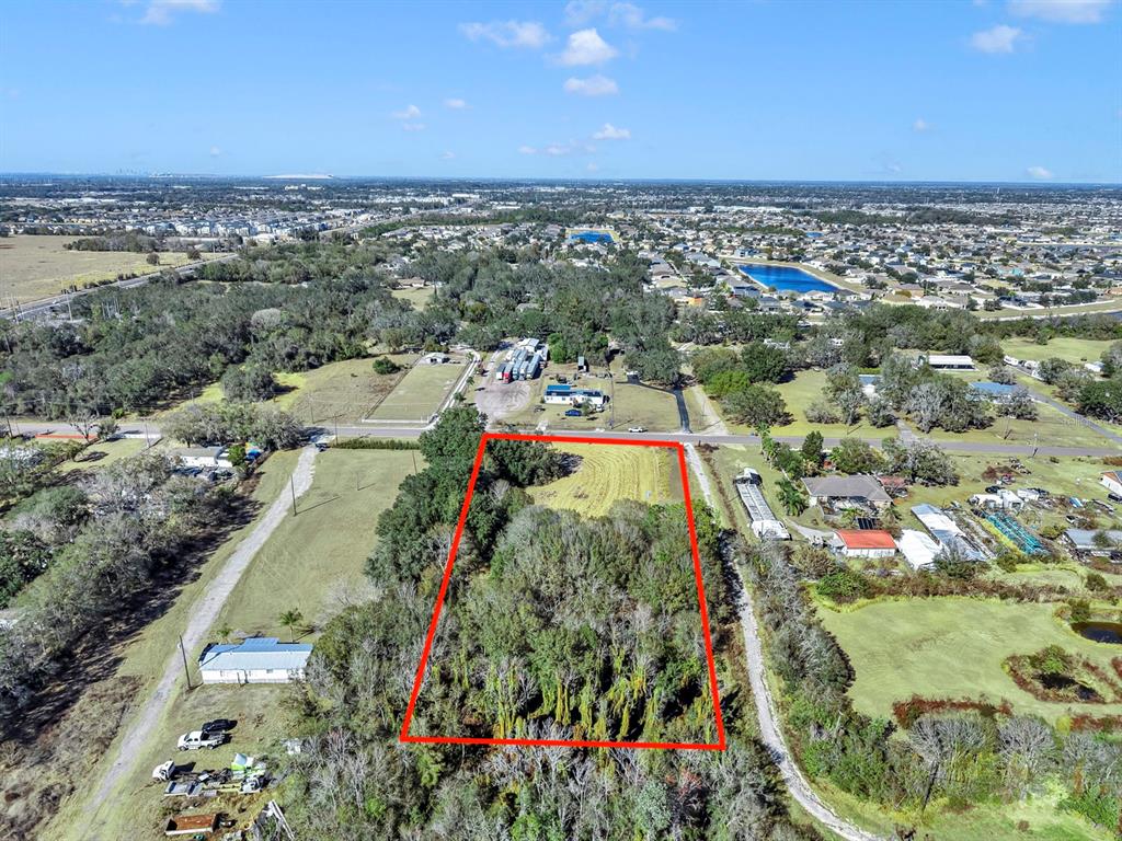10611 Sumner Road Wimauma, FL 33598 - Photo 28 of 30 an aerial view of residential houses with outdoor space