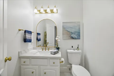 a bathroom with a sink mirror and toilet