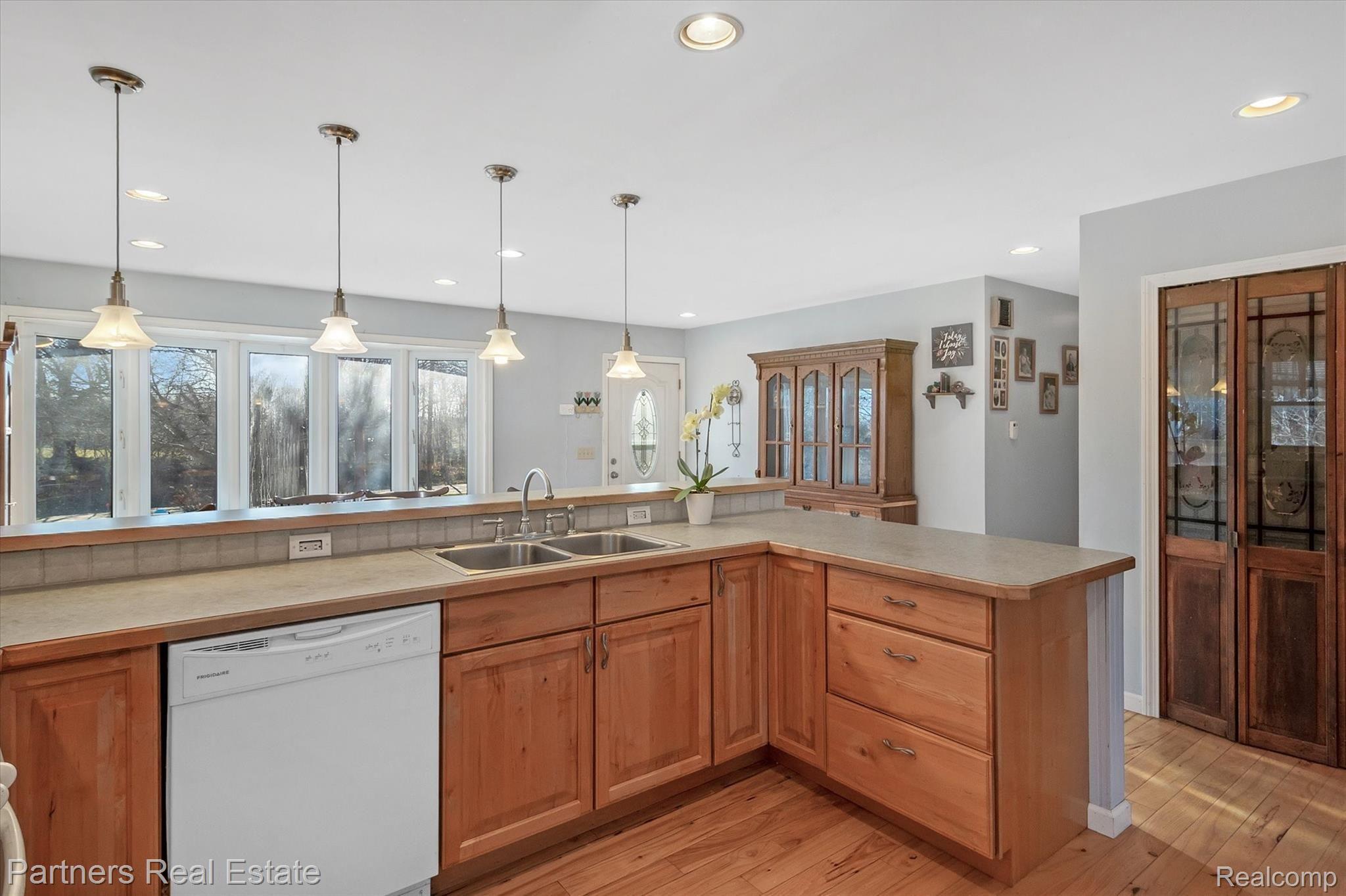 6400 Sharpe Road Fowlerville, MI 48836 - Photo 12 of 52 Beautiful Kitchen cabinets and to the right is your massive walk in pantry! Heart eyes!