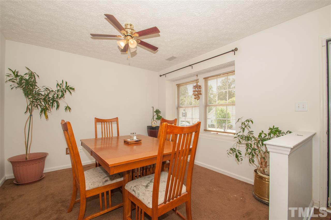 2232 Springhill Avenue Raleigh, NC 27603 - Photo 2 of 19 a dining room with furniture potted plants and a chandelier