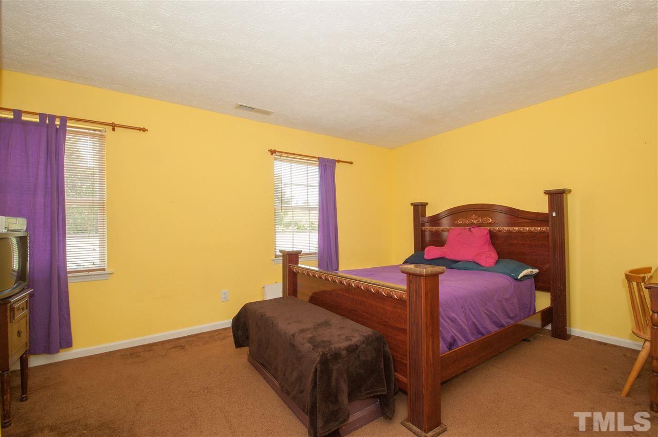 2232 Springhill Avenue Raleigh, NC 27603 - Photo 11 of 19 a bedroom with a bed and wooden floor