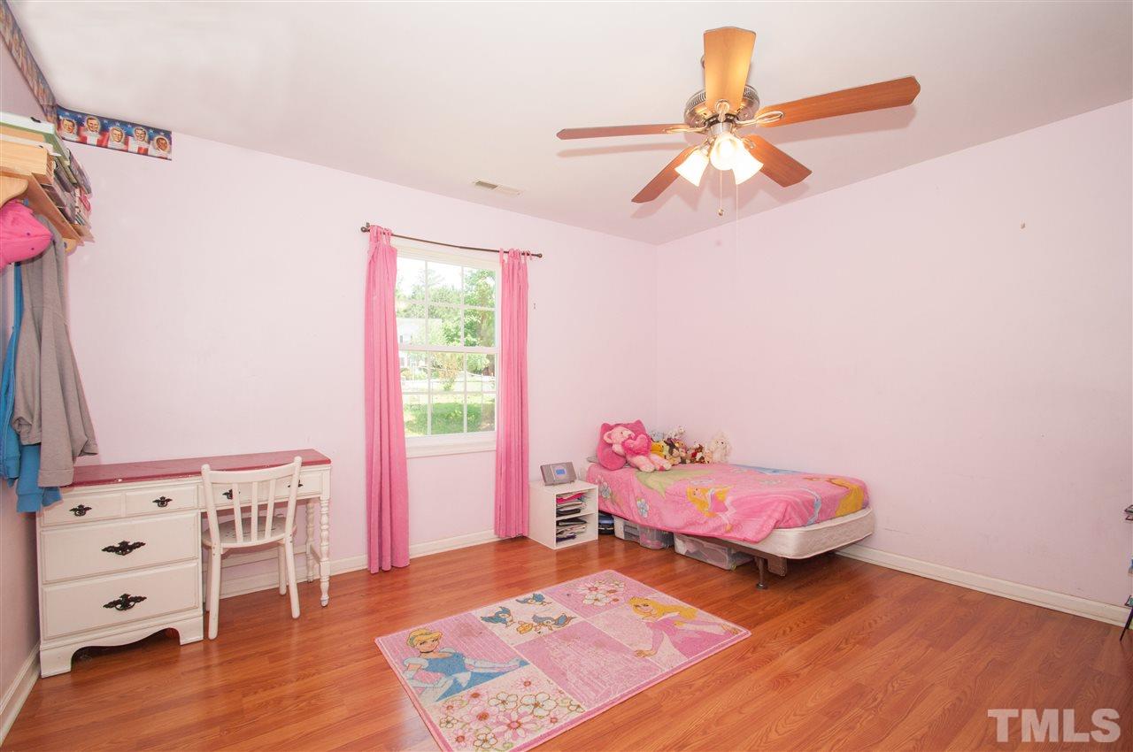 2232 Springhill Avenue Raleigh, NC 27603 - Photo 13 of 19 a bedroom with a bed and a dresser in it