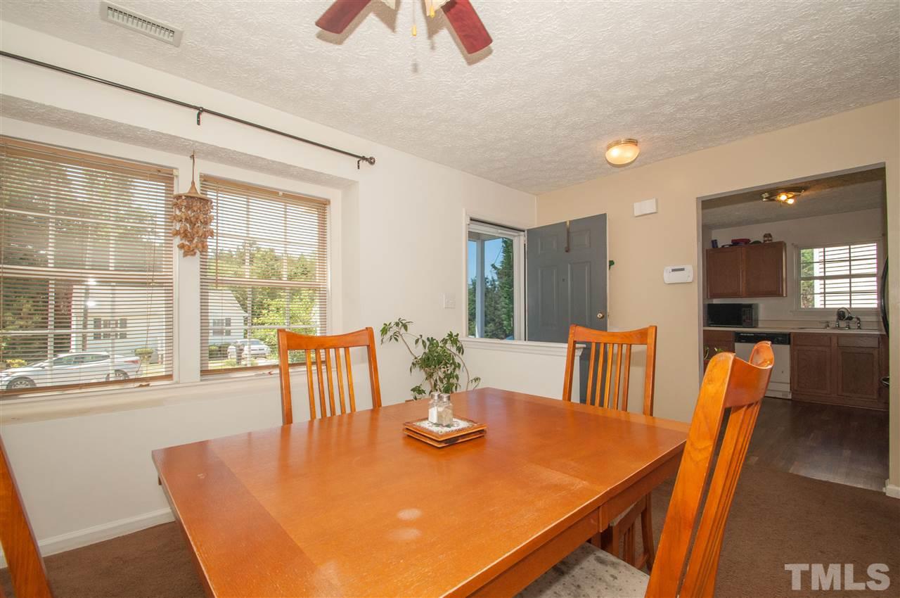 2232 Springhill Avenue Raleigh, NC 27603 - Photo 3 of 19 a view of a dining room with furniture window and wooden floor