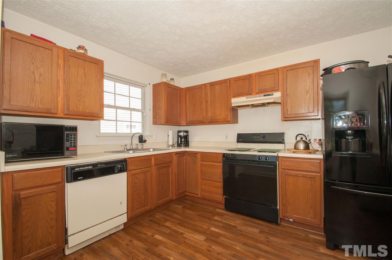 2232 Springhill Avenue Raleigh, NC 27603 - Photo 4 of 19 a kitchen with a refrigerator stove top oven and sink