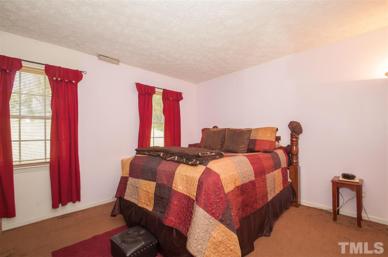 2232 Springhill Avenue Raleigh, NC 27603 - Photo 9 of 19 a bedroom with a bed and a window
