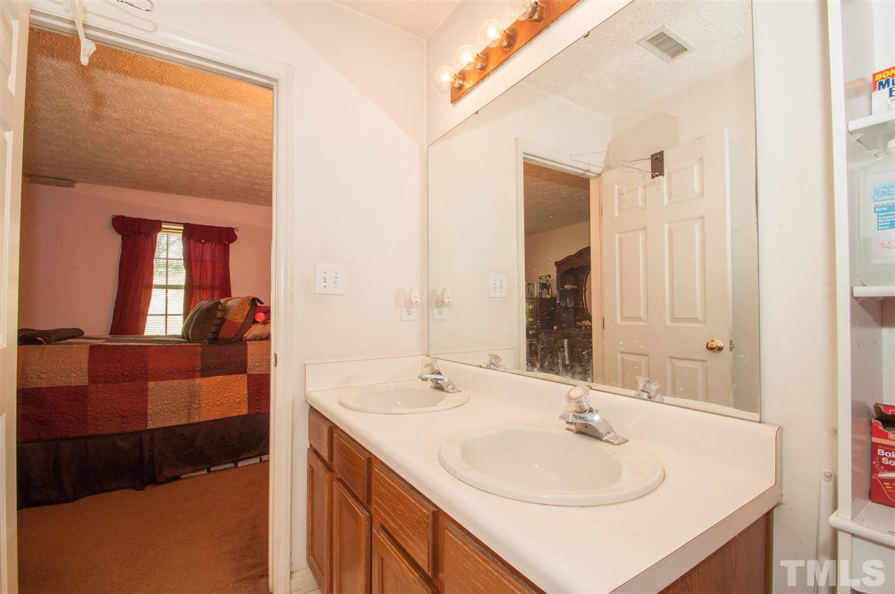 2232 Springhill Avenue Raleigh, NC 27603 - Photo 10 of 19 a en suite bathroom with a sink and a mirror