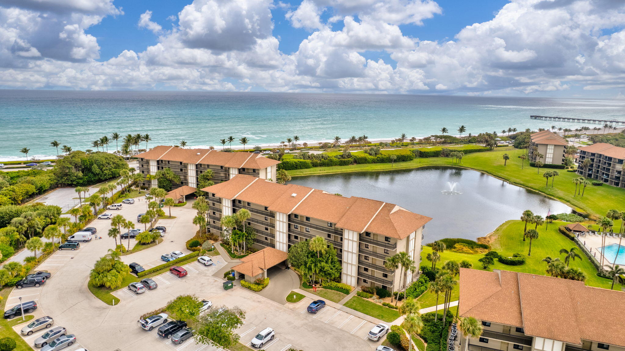 201 South Seas Drive, Unit 302 Jupiter, FL 33477 - Photo 1 of 19 an aerial view of a city with lots of residential buildings ocean and mountain view in back