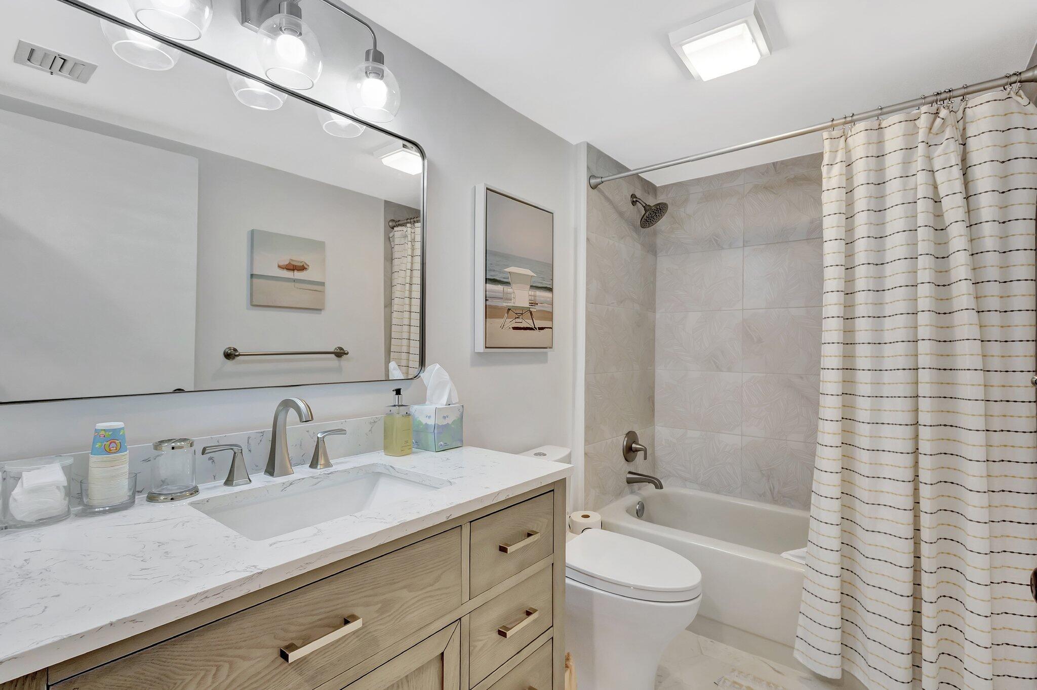 201 South Seas Drive, Unit 302 Jupiter, FL 33477 - Photo 14 of 19 a bathroom with a granite countertop sink toilet and shower