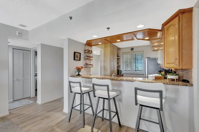 a living room with furniture a flat screen tv and a large window