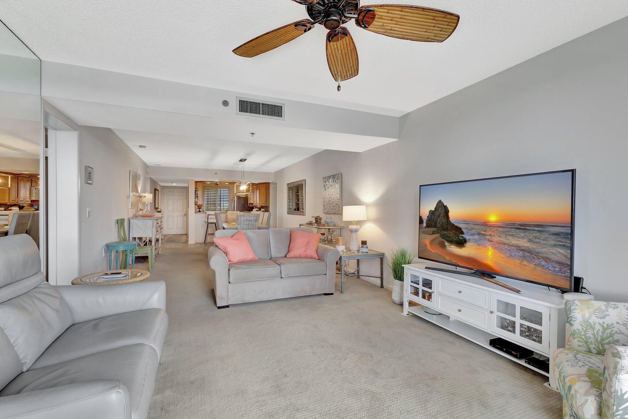 201 South Seas Drive, Unit 302 Jupiter, FL 33477 - Photo 17 of 19 a living room with furniture and a flat screen tv