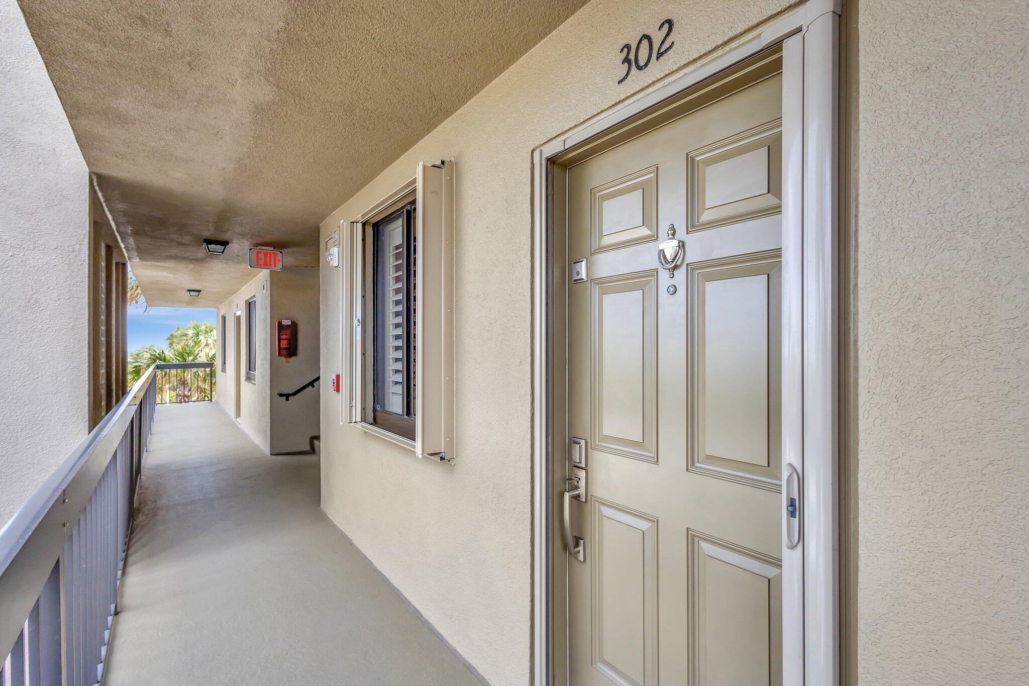 201 South Seas Drive, Unit 302 Jupiter, FL 33477 - Photo 8 of 19 a view of a hallway with wooden shelves