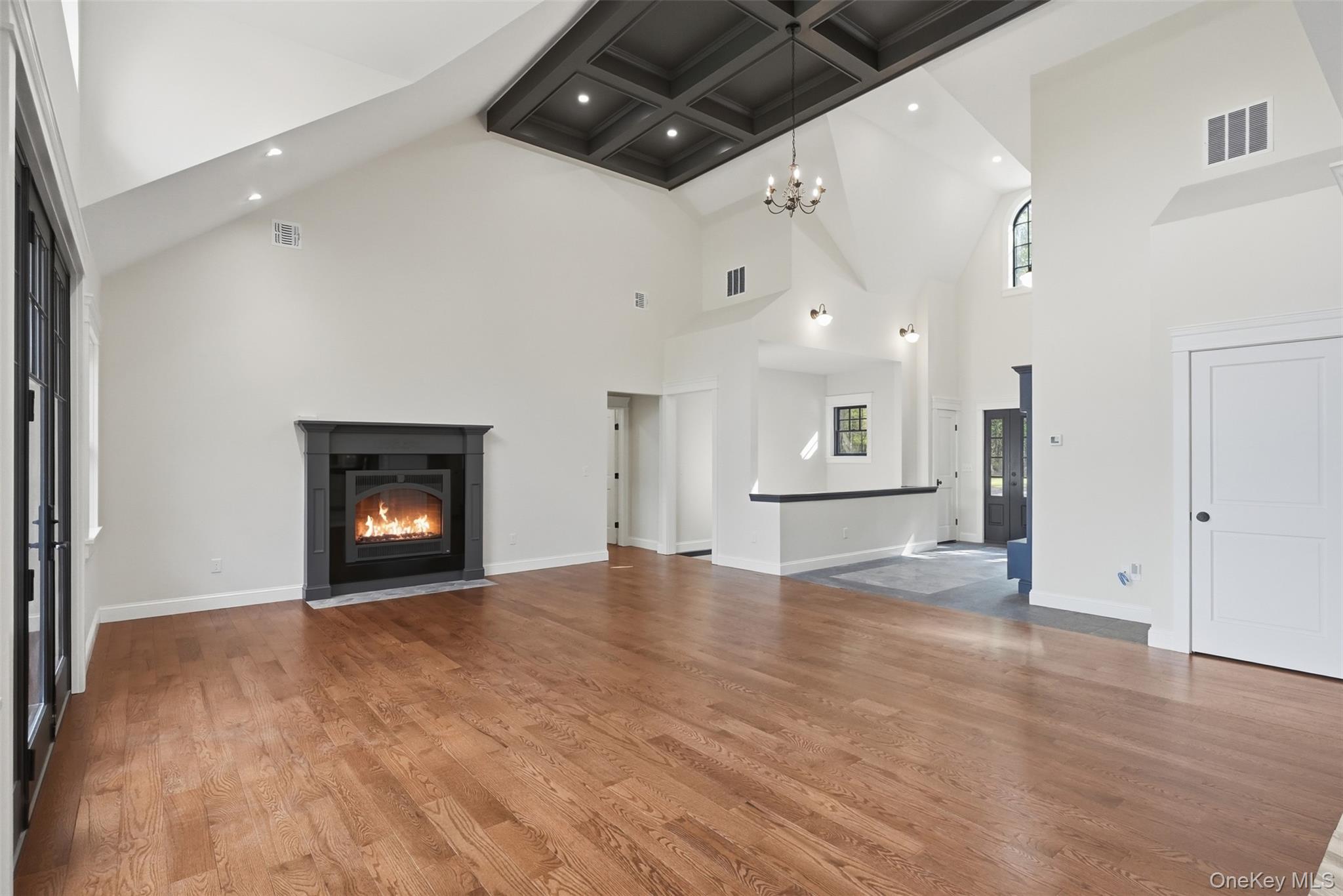 300 Van Tuyl Road Barryville, NY 12719 - Photo 25 of 50 an empty room with wooden floor fireplace and windows