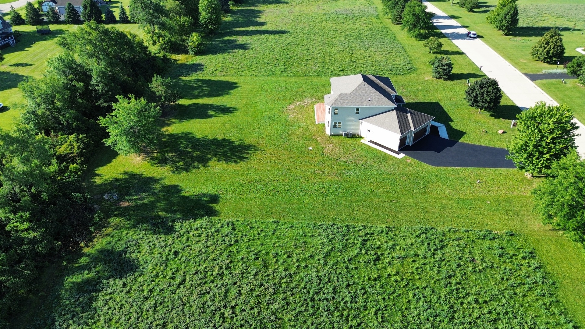 7304 Briar Drive Spring Grove, IL 60081 - Photo 42 of 50 an aerial view of residential house with outdoor space and trees all around