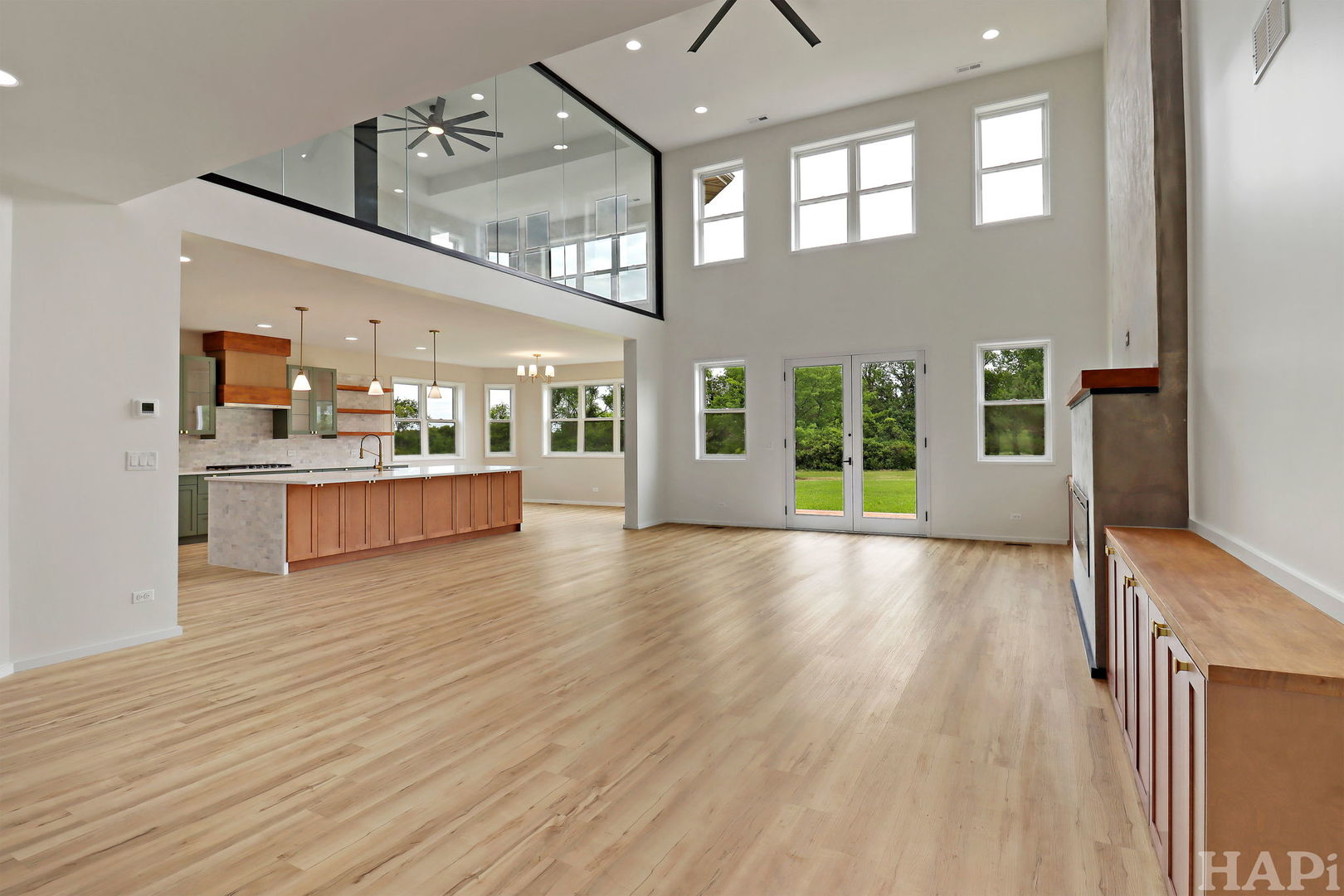 7304 Briar Drive Spring Grove, IL 60081 - Photo 6 of 50 a view of a living room and kitchen with furniture wooden floor and windows